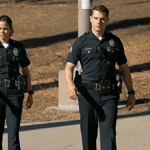 Police Officers Walking With Williamson Badge GIF
