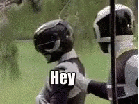 Two Power Rangers One Helmeted Saying Hey