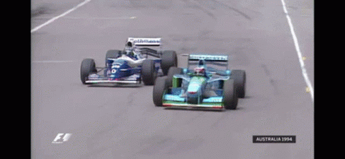 Two Racing Cars On A Race Track With The Year 1994 On The Bottom GIF