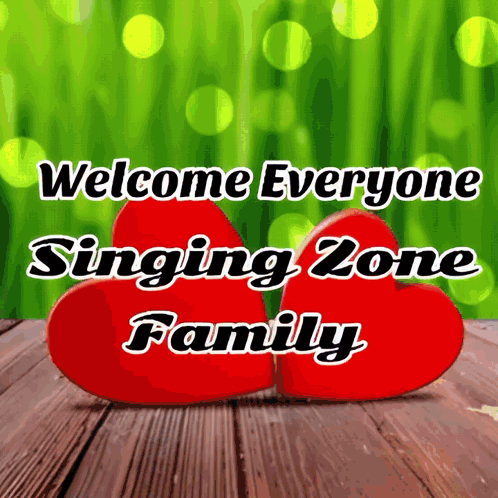 Two Red Hearts On A Wooden Table With The Words Welcome Everyone Singing Zone Family Below Them GIF