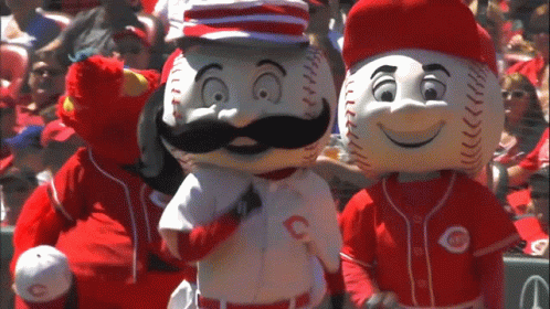 Two Reds Mascots Are Standing Next To Each Other In A Crowd GIF
