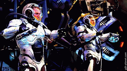 Two Robots Are Standing Next To Each Other With The Number 05 On The Bottom Left GIF
