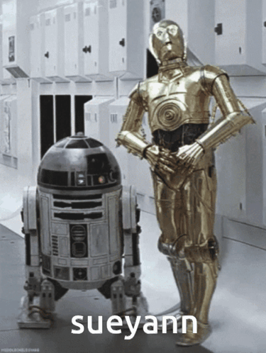 Two Robots Standing Next to Each Other