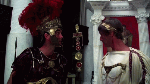 Two Roman Soldiers Standing Next To Each Other With A Sign That Says ' S.r.o.m. ' On It GIF