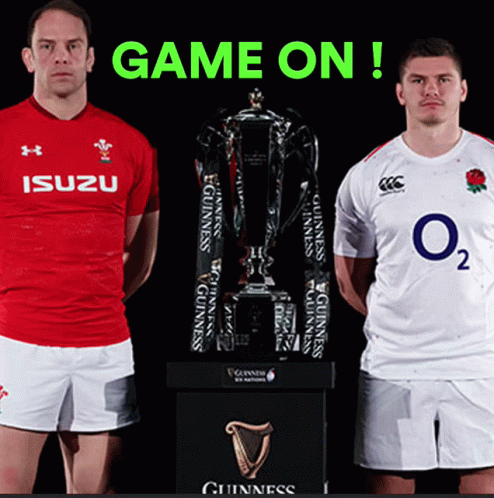 Two Rugby Players Are Standing Next To A Trophy With The Words Game On Behind Them GIF