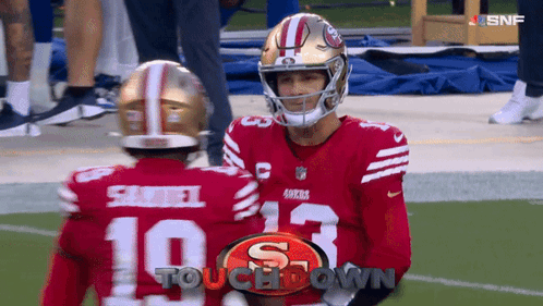 Two San Francisco 49Ers Football Players Are Talking On The Field GIF