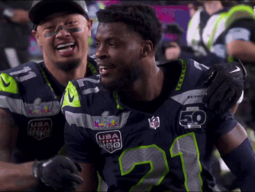 Two Seahawks Players Hugging GIF