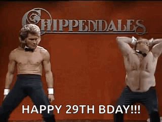 Two Shirtless Men Are Dancing In Front Of A Sign That Says Happy 29Th Bday . GIF