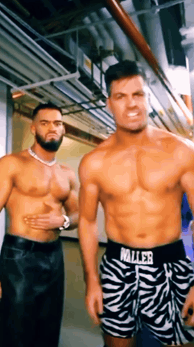 two shirtless men are standing next to each other in a hallway wearing zebra print shorts that say waller