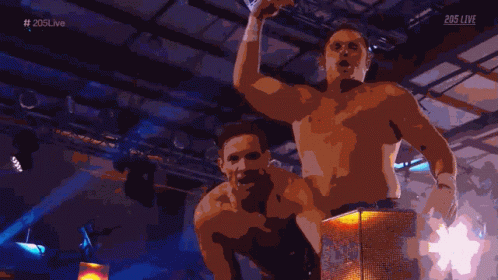 Two Shirtless Men In Front Of 203Live Screen GIF