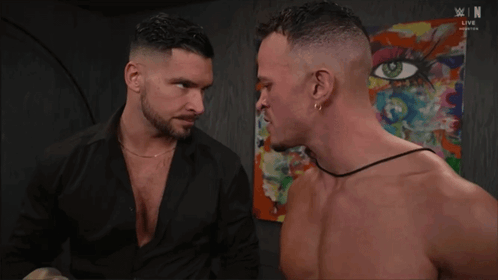 Two Shirtless Men In Front Of Woman Painting GIF