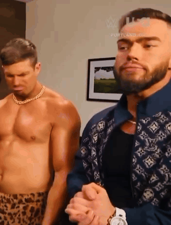 two shirtless men standing next to each other in a room .
