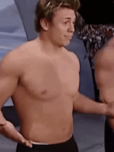 Two Shirtless Men Standing Together GIF
