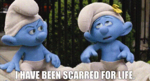 Two Smurfs Are Sitting Next To Each Other On A Bed . GIF