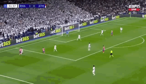 Two Soccer Players Are Celebrating A Goal During A Soccer Game . GIF