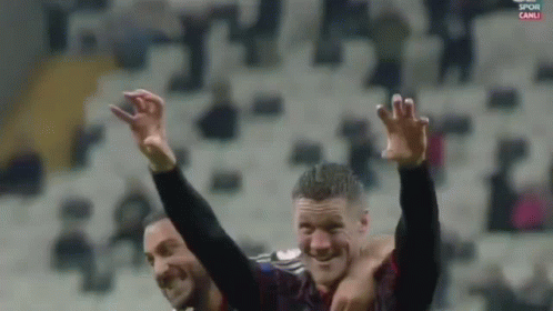 two soccer players are celebrating with their arms in the air and the words spor canli on the bottom