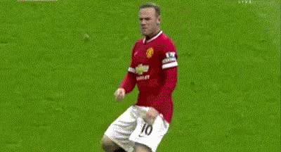Two Soccer Players Are Fighting For The Ball On A Field . One Of The Players Has The Number 18 On His Shirt . GIF