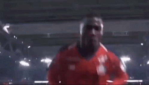 Two Soccer Players Are Giving The Peace Sign While Standing Next To Each Other . GIF