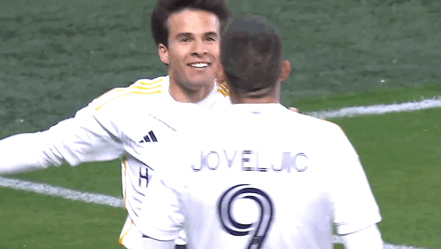 Two Soccer Players Are Hugging And One Has The Number 9 On His Jersey GIF
