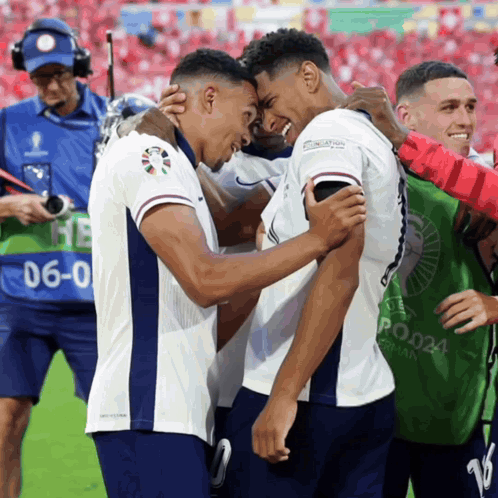 two soccer players are hugging each other and one has the number 6 on his back