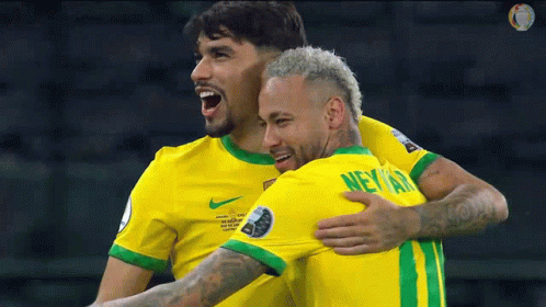 two soccer players are hugging each other and one of them has the name neymar on his shirt