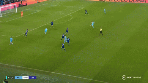Two Soccer Players Are Hugging Each Other On A Field With A Score Of 5-0 On The Screen GIF