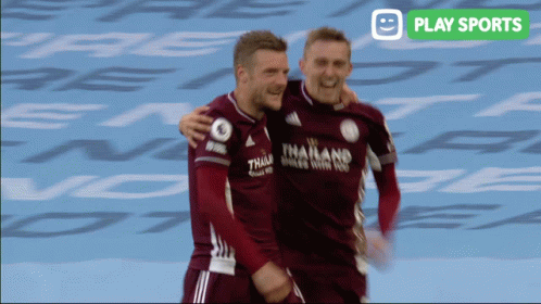 Two Soccer Players Are Hugging Each Other With A Play Sports Logo In The Background GIF