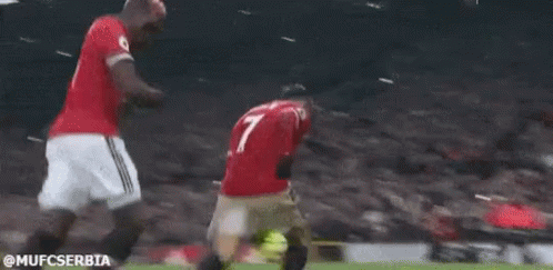Two Soccer Players Are Kneeling Down On The Field . GIF