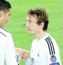 Two Soccer Players Are Shaking Hands On The Field And One Has A Fly Emirates Logo On His Shirt GIF