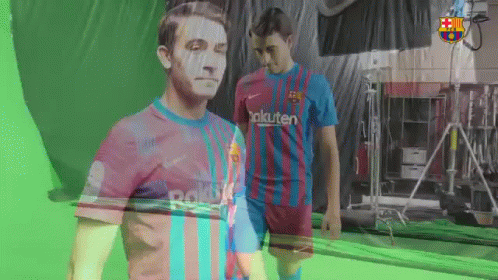 two soccer players are standing in front of a green screen