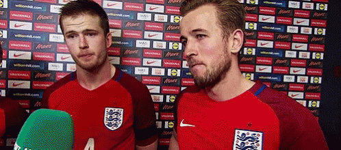 Two Soccer Players Are Standing Next To Each Other In Front Of A Wall With Nike Advertisements GIF