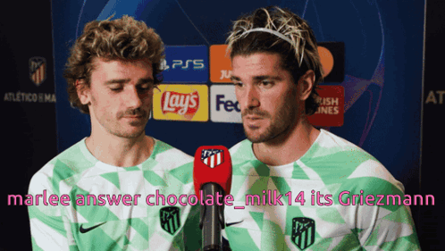 Two Soccer Players Are Talking Into Microphones In Front Of A Sign That Says Ps5 GIF