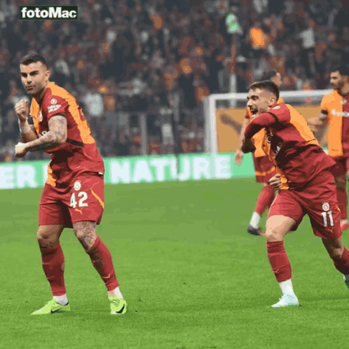 Two Soccer Players Celebrate Goal with Nature Ad