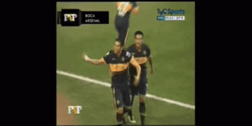 Two Soccer Players Celebrating Goal in Front of TV Saying Pt