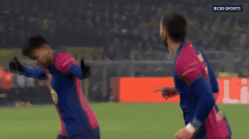 Two Soccer Players Celebrating Goal