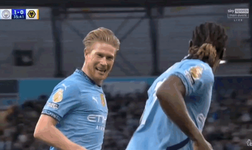 Two Soccer Players Celebrating Goal