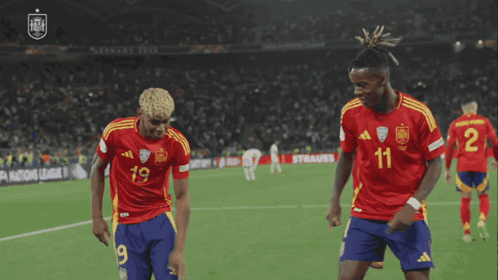 Two Soccer Players Dancing in Number 11 Jerseys