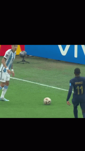 Two Soccer Players Fighting for Ball, One in Adidas Jersey