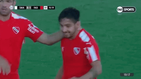 Two Soccer Players Fist Bumping