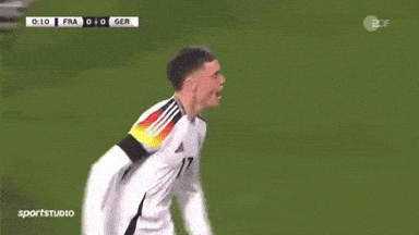 Two Soccer Players High Five During Game
