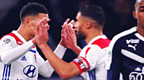 Two Soccer Players High Five One in Hyundai Jersey