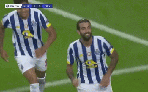 two soccer players in blue and white striped jerseys are running on a field .