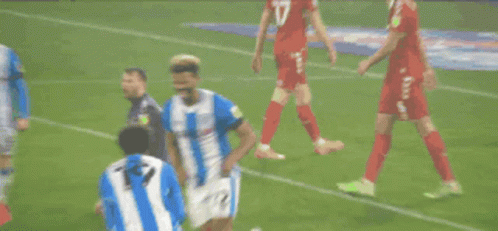 Two Soccer Players in Blue and White Striped Uniforms Number 7