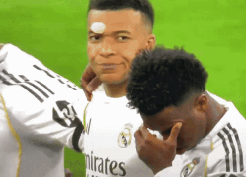 Two Soccer Players In Emirates Jerseys Hugging GIF