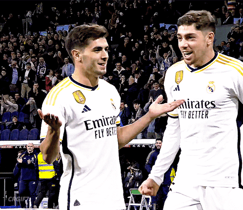 Two Soccer Players in Emirates Jerseys
