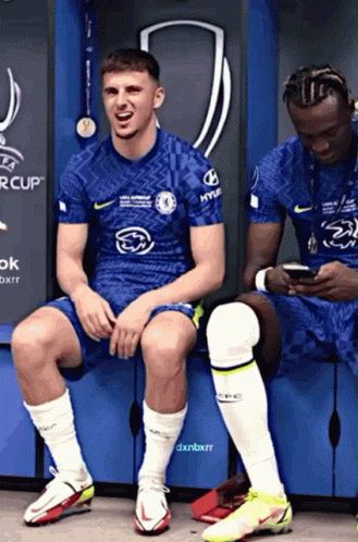 Two Soccer Players in Locker Room, One in Hyundai Shirt