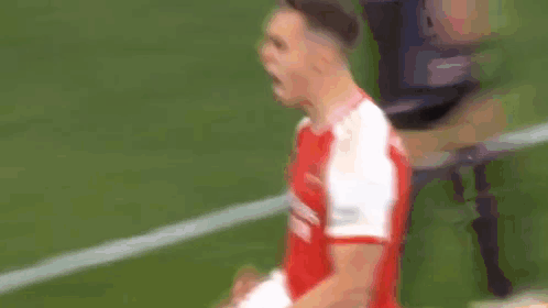 Two Soccer Players in Red and White Fighting