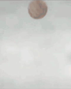 Two Soccer Players In Red Jerseys And Blue Shorts Kick A Ball GIF
