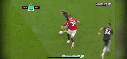 Two Soccer Players Laying on Field, One With Emirates