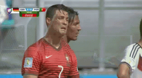Two Soccer Players Next to Coca Cola Scoreboard